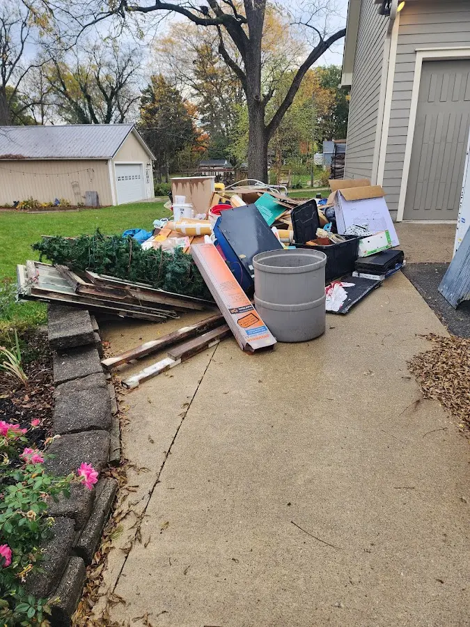 Dumpster being loaded with debris for Residential Dumpster Rental in Andrews